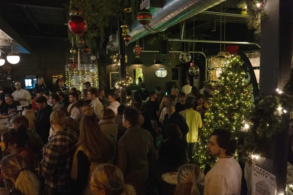 A full room under the holiday lights